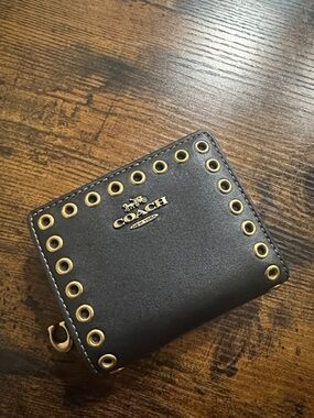 Coach Black Leather Zip-Around Wallet with Gold Grommet Detail